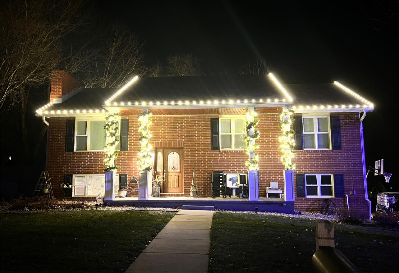 Finished Install — warm white roofline & lit garland columns