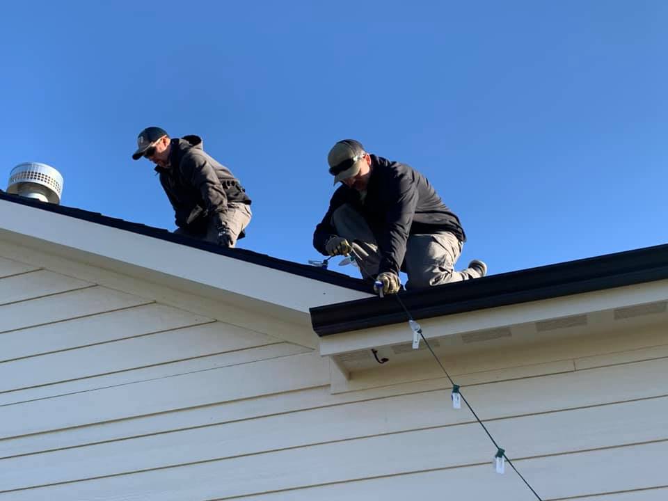 Rooftop Crew — clipping C9 socket cord to gutterline